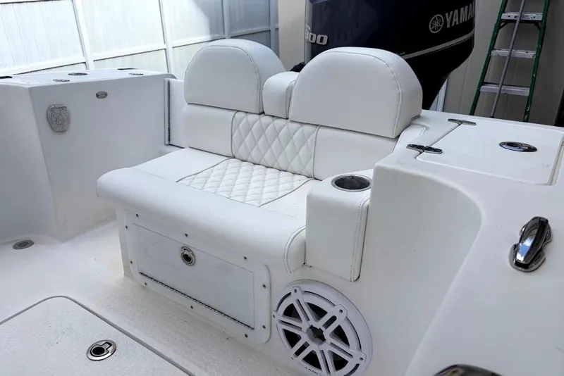 Slide: The Image of Covered Concept 27 boat on trailer, parked in driveway, 2015 model. - 5