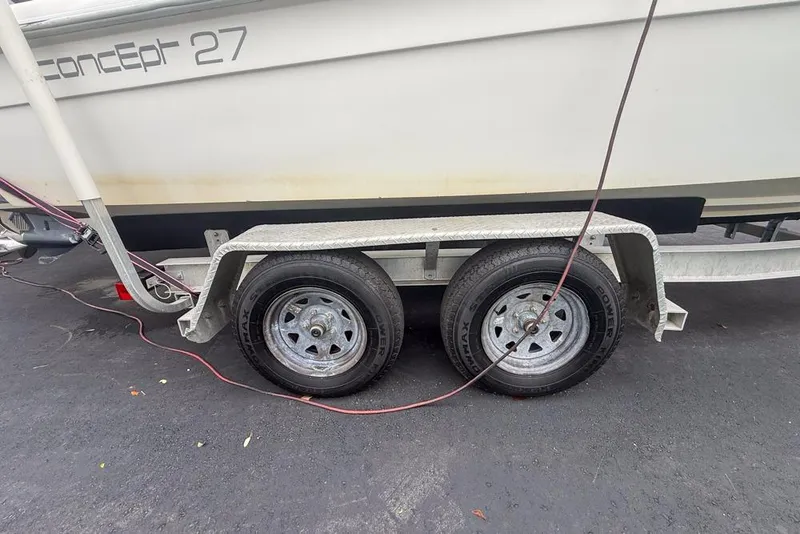 Slide: The Image of Yamaha 300 outboard motor on a Concept 27 boat, 2015 model, parked outdoors. - 72