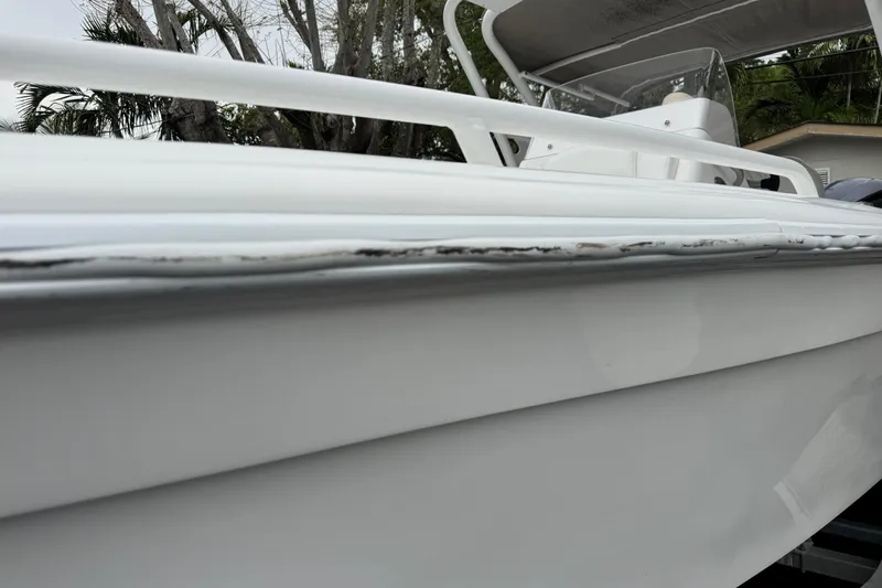 Slide: The Image of Open storage compartment on Concept 27 boat, featuring a red and black strap inside. - 75