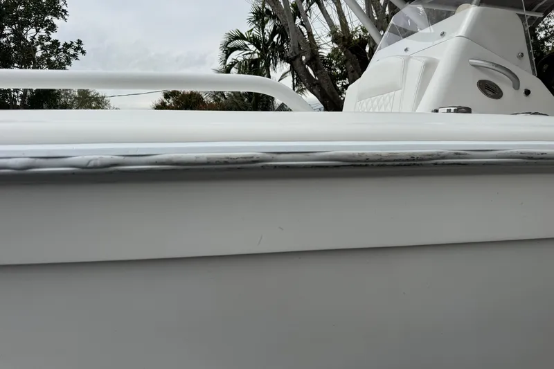 Slide: The Image of Open storage compartment on Concept 27 boat, featuring a yellow strap, 2015 model. - 76