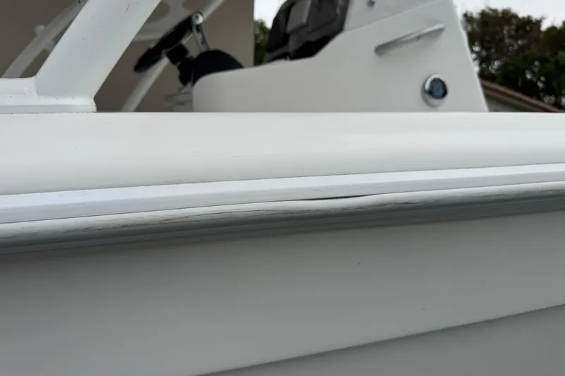 Slide: The Image of Interior view of a 2015 Concept 27 boat, featuring sleek white design and speaker system. - 78