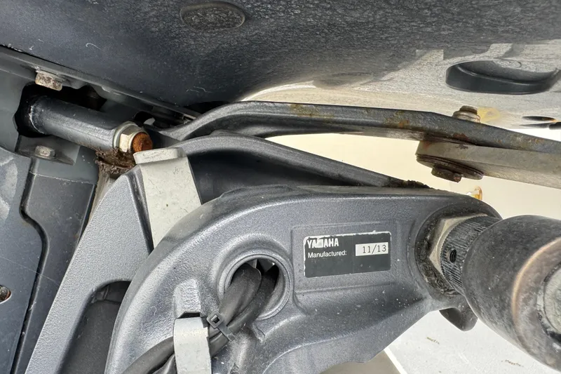 Slide: The Image of White interior of a 2015 Concept 27 boat, featuring a storage compartment and clean deck. - 80