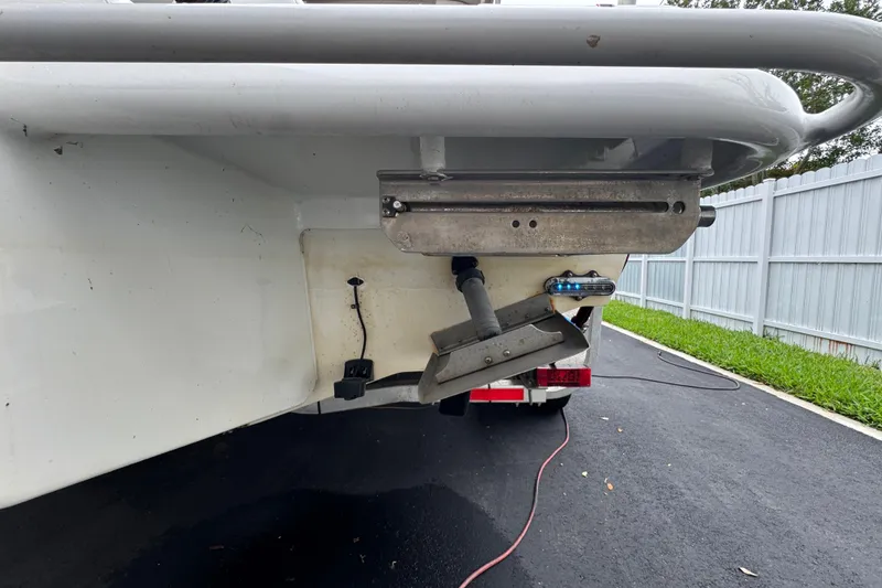 Slide: The Image of White Concept 27 boat interior, 2015 model, under a bright blue sky with clouds. - 89