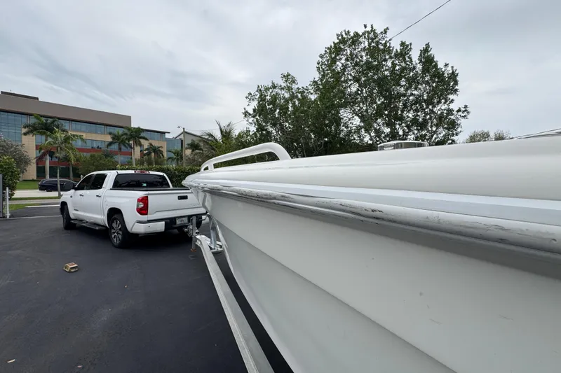 Slide: The Image of Interior view of a 2015 Concept 27 boat, showcasing sleek white design and rod holders. - 92