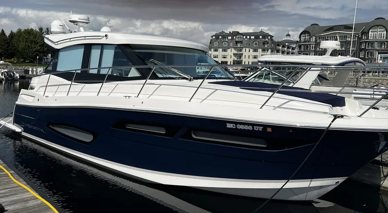 Slide: The Image of 2024 Regal 38 Grand Coupe yacht docked at marina. - 0