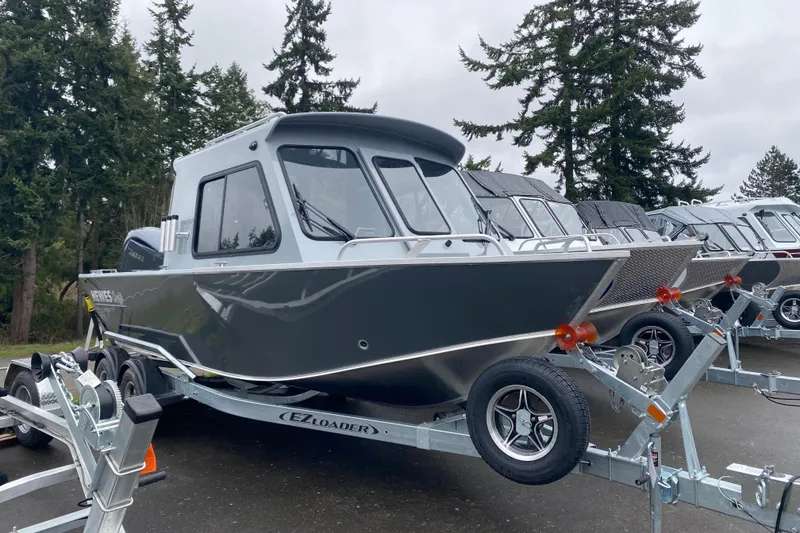 The Image of 2026 Hewescraft 200 ProV Hard Top boat on trailer, surrounded by trees. - 1