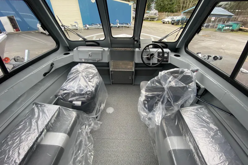 Slide: The Image of Interior of 2026 Hewescraft 200 ProV Hard Top boat, featuring covered seats and steering console. - 10