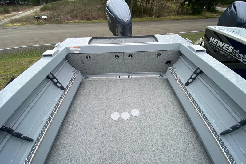 Slide: The Image of 2026 Hewescraft 200 ProV Hard Top boat interior with spacious deck and storage compartments. - 13