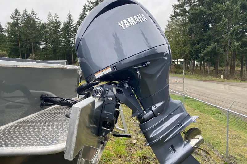 Slide: The Image of 2026 Hewescraft 200 ProV Hard Top with Yamaha outboard motor in a wooded area. - 5