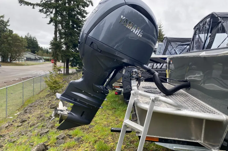 Slide: The Image of 2026 Hewescraft 200 ProV Hard Top with Yamaha outboard motor, parked outdoors. - 7