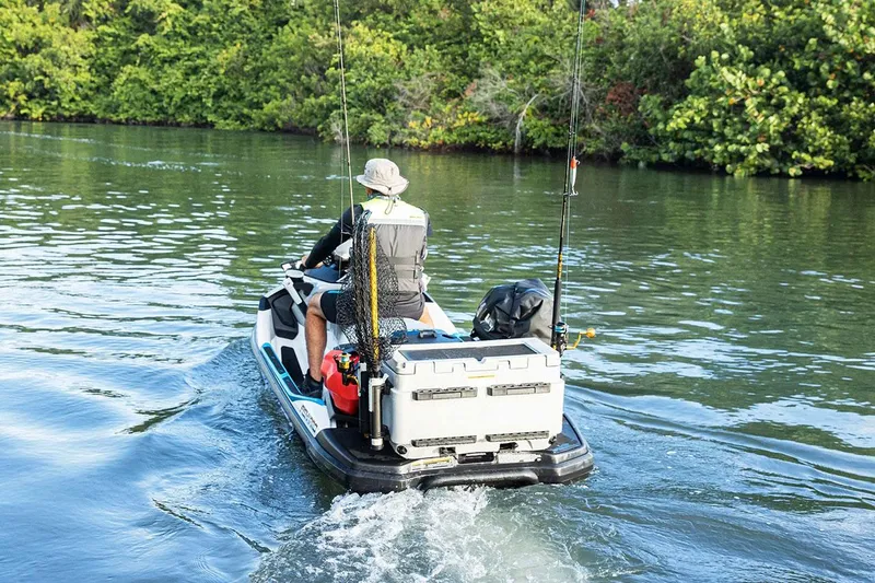 Slide: The Image of Manufacturer Provided Image: 2025 Sea-Doo FishPro Sport 170 on water, equipped for fishing, surrounded by lush greenery. - 18