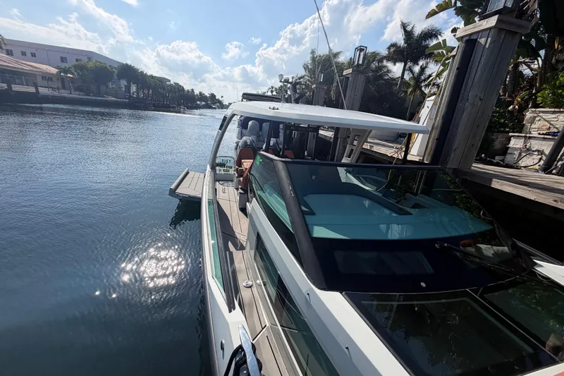 Slide: The Image of 2024 Saxdor 320 GTO docked by a scenic waterfront under a sunny sky. - 11