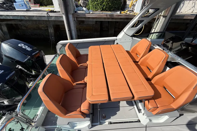 Slide: The Image of 2024 Saxdor 320 GTO boat with orange seating and table setup. - 22