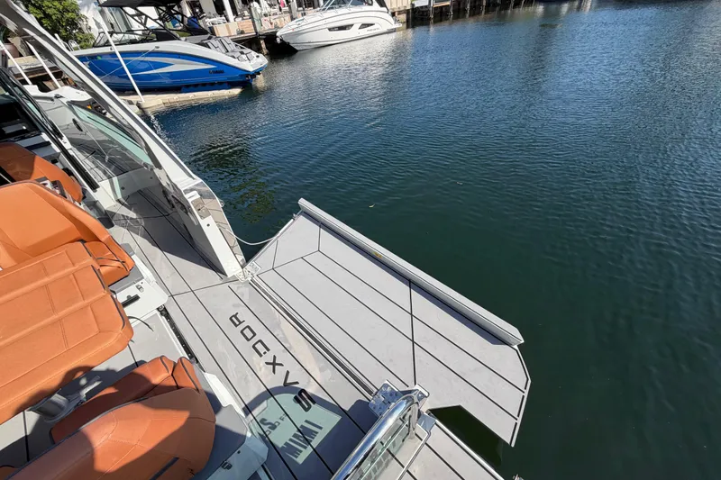 Slide: The Image of 2024 Saxdor 320 GTO boat with orange seats docked by the water. - 26