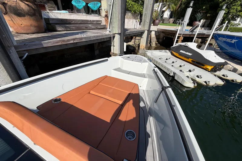 Slide: The Image of 2024 Saxdor 320 GTO boat docked, featuring a sleek design and comfortable seating. - 27