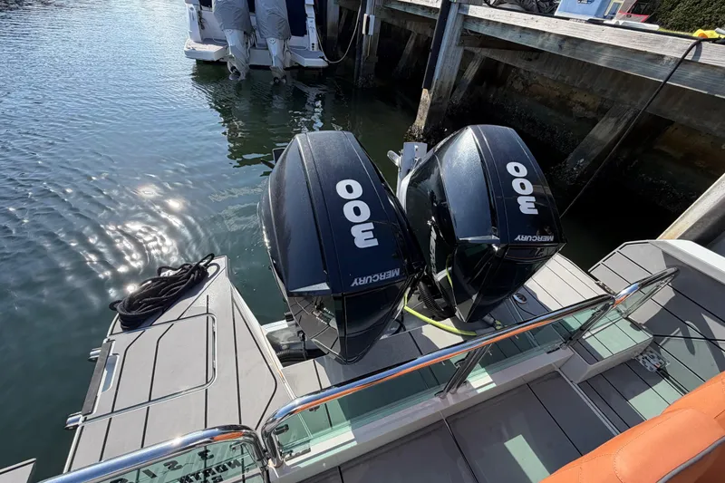 Slide: The Image of 2024 Saxdor 320 GTO with twin Mercury 300 engines docked by the water. - 30