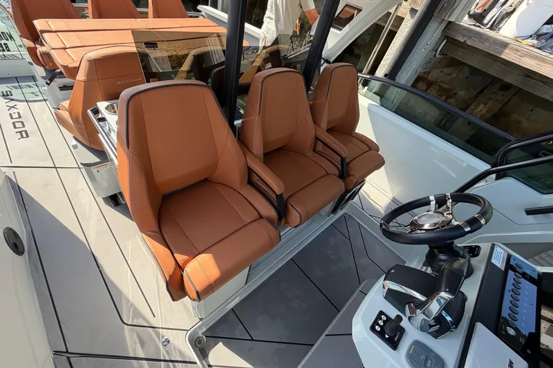 Slide: The Image of 2024 Saxdor 320 GTO boat interior with brown leather seats and modern steering console. - 18