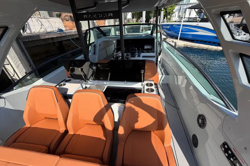 Slide: The Image of 2024 Saxdor 320 GTO boat interior with orange seats and modern dashboard. - 19