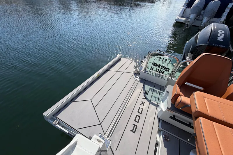 Slide: The Image of 2024 Saxdor 320 GTO boat with orange seating and Mercury outboard engines on water. - 29