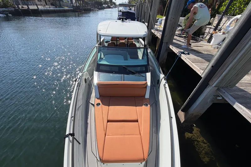 Slide: The Image of 2024 Saxdor 320 GTO docked, featuring sleek design and orange seating. - 8