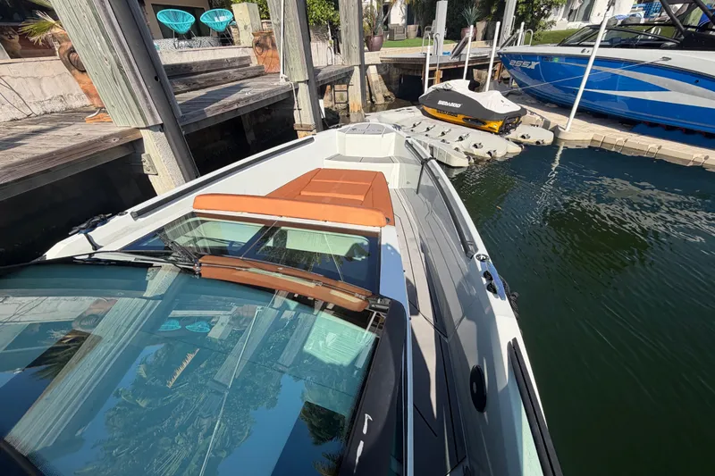 Slide: The Image of 2024 Saxdor 320 GTO boat docked, showcasing sleek design and modern features. - 9