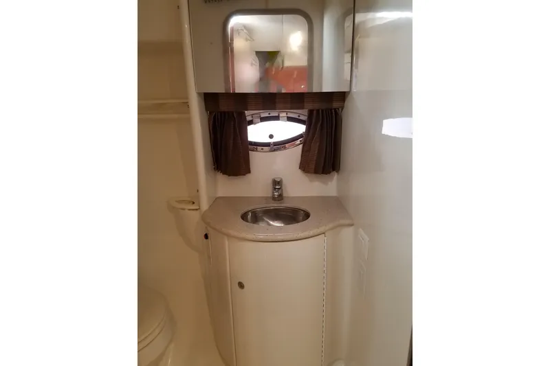Slide: The Image of 2005 Formula 31 Performance Cruiser bathroom with sink, mirror, and porthole window. - 11