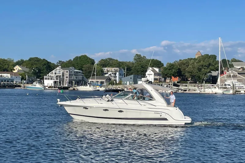 Slide: The Image of 2005 Formula 31 Performance Cruiser on scenic waterfront with houses and marina. - 3