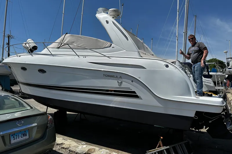 Slide: The Image of 2005 Formula 31 Performance Cruiser on dry dock with a person standing beside it. - 4