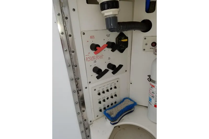 Slide: The Image of Control panel of a 2005 Formula 31 Performance Cruiser with switches and fire extinguisher. - 9