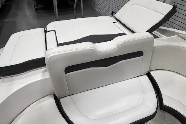 Slide: The Image of 2013 Chaparral 226 SSi boat interior seating with white and black upholstery. - 11