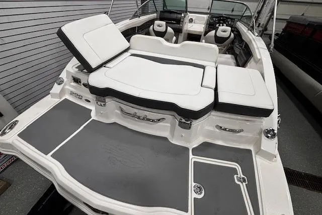 Slide: The Image of 2013 Chaparral 226 SSi boat interior with white seating and gray flooring. - 13