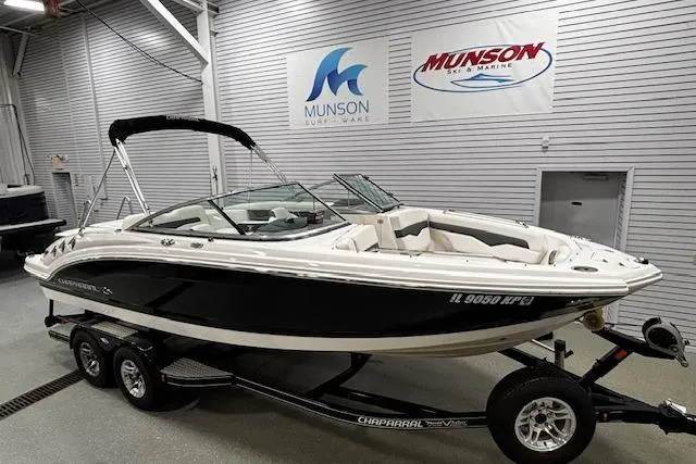 Slide: The Image of 2013 Chaparral 226 SSi boat on trailer in showroom with Munson Marine signage. - 15