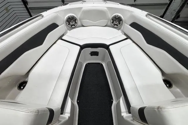 Slide: The Image of Interior view of 2013 Chaparral 226 SSi boat, featuring sleek white seating and modern design. - 22