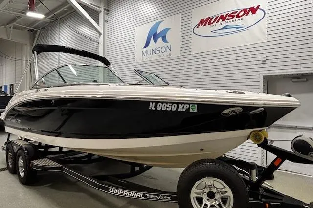 Slide: The Image of 2013 Chaparral 226 SSi boat on trailer in showroom, Munson Ski & Marine signage. - 27