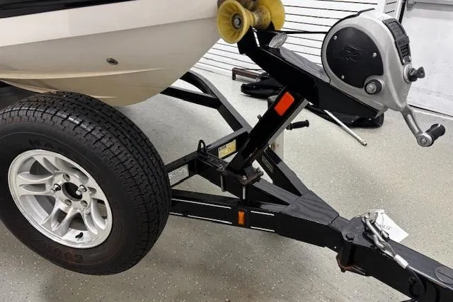 Slide: The Image of Trailer hitch and wheel of 2013 Chaparral 226 SSi boat in garage setting. - 28