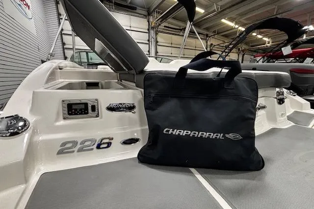 Slide: The Image of 2013 Chaparral 226 SSi boat interior with branded bag in a showroom. - 29