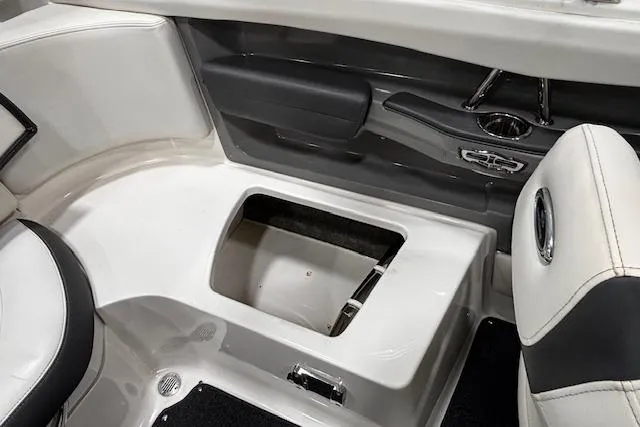 Slide: The Image of Interior view of a 2013 Chaparral 226 SSi boat, featuring seating and storage compartment. - 31