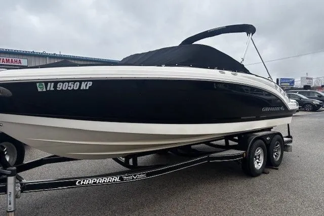 Slide: The Image of 2013 Chaparral 226 SSi boat on trailer, black and white design, parked outdoors. - 32