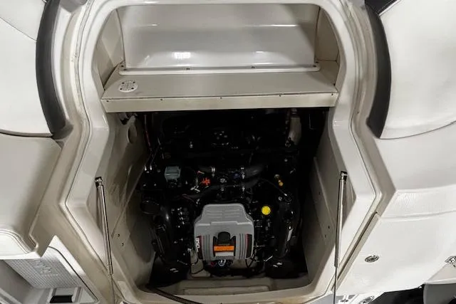 Slide: The Image of Engine compartment of a 2013 Chaparral 226 SSi boat, showcasing the engine details. - 33
