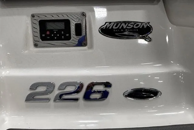 Slide: The Image of 2013 Chaparral 226 SSi boat with Munson Marine branding and control panel. - 36