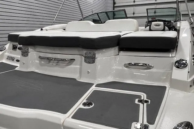 Slide: The Image of 2013 Chaparral 226 SSi boat with sleek design and comfortable seating in a showroom. - 37