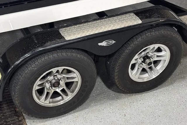 Slide: The Image of Trailer wheels of a 2013 Chaparral 226 SSi boat on a textured garage floor. - 39