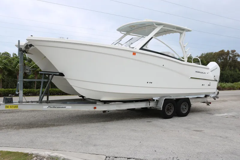 The Image of 2024 World Cat 280 DC-X boat on trailer, parked outdoors. - 0