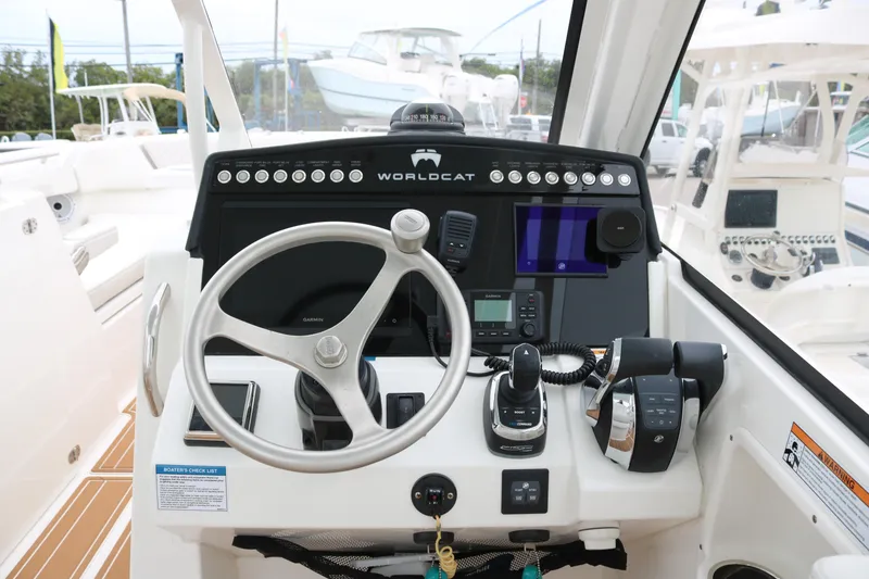 Slide: The Image of Cockpit of 2024 World Cat 280 DC-X boat with steering wheel and control panel. - 11