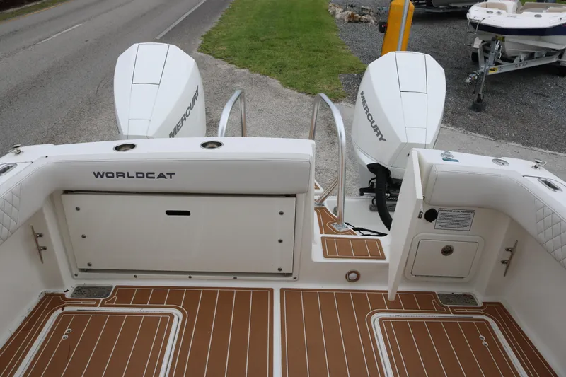 Slide: The Image of 2024 World Cat 280 DC-X boat with twin Mercury engines, featuring a spacious deck. - 16