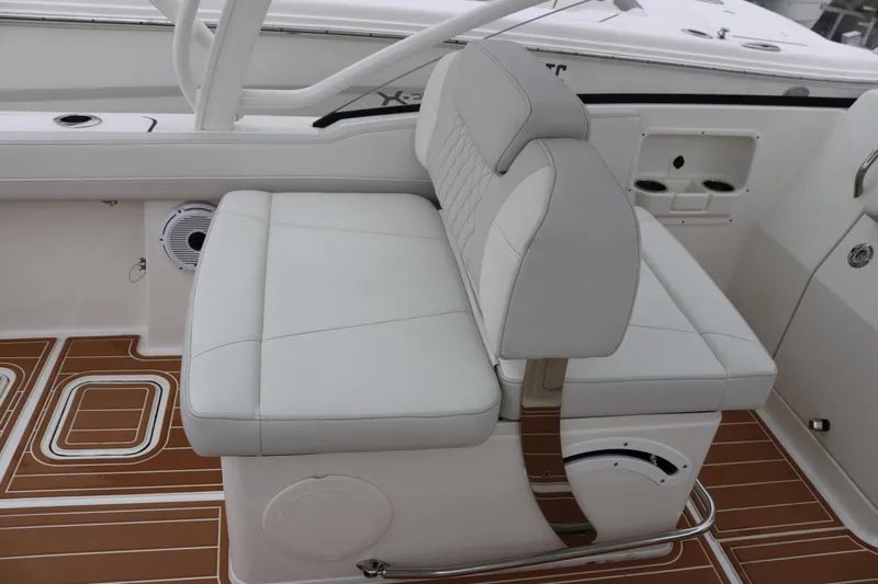 Slide: The Image of 2024 World Cat 280 DC-X boat interior with white seating and brown flooring. - 17