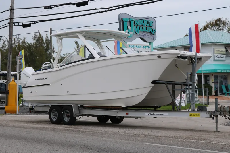 Slide: The Image of 2024 World Cat 280 DC-X boat on trailer at Unique Marine dealership. - 2