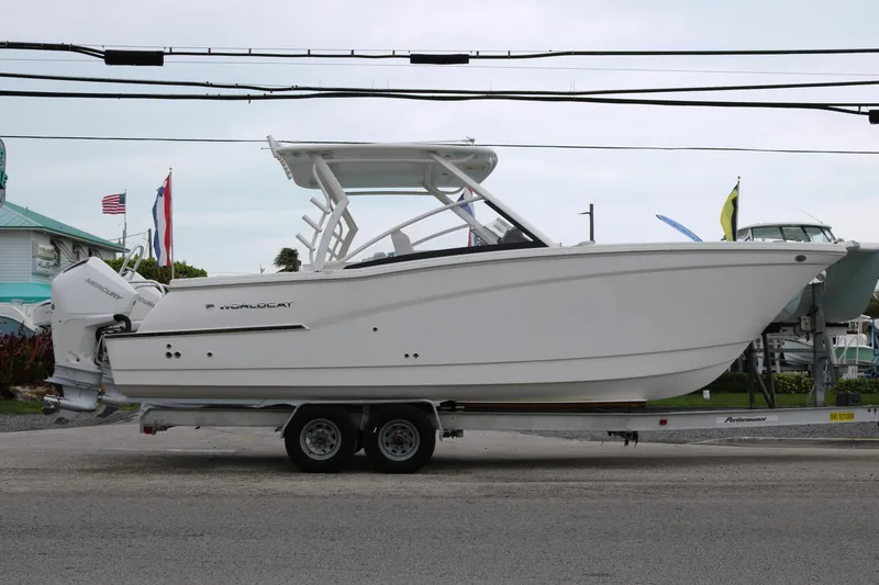 Slide: The Image of 2024 World Cat 280 DC-X boat on trailer, side view, outdoor display. - 3