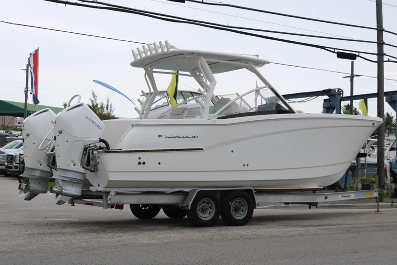 Slide: The Image of 2024 World Cat 280 DC-X boat on trailer, featuring dual Mercury engines. - 4