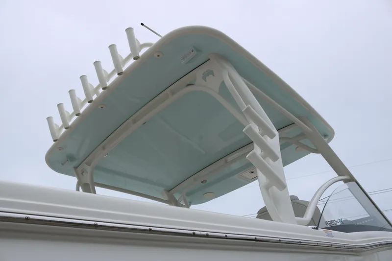 Slide: The Image of 2024 World Cat 280 DC-X boat with rod holders and sleek design. - 5